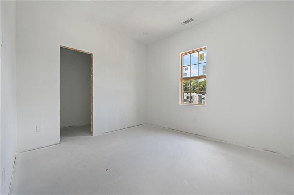 8200 Main Street, Unit 1306 Woodstock, GA 30188 - Photo 18 of 43 an empty room with windows and closet