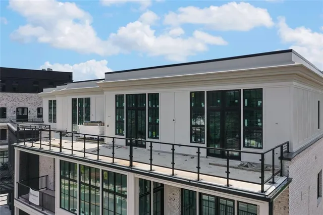a view of house with roof deck and furniture