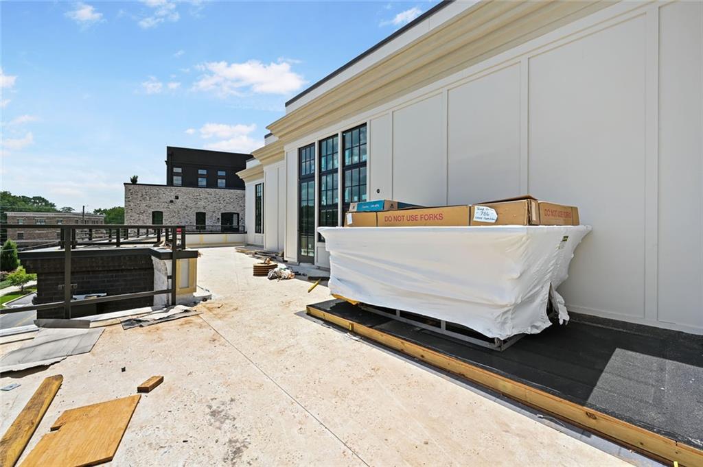 8200 Main Street, Unit 1306 Woodstock, GA 30188 - Photo 27 of 43 a wooden bench sitting in front of a building
