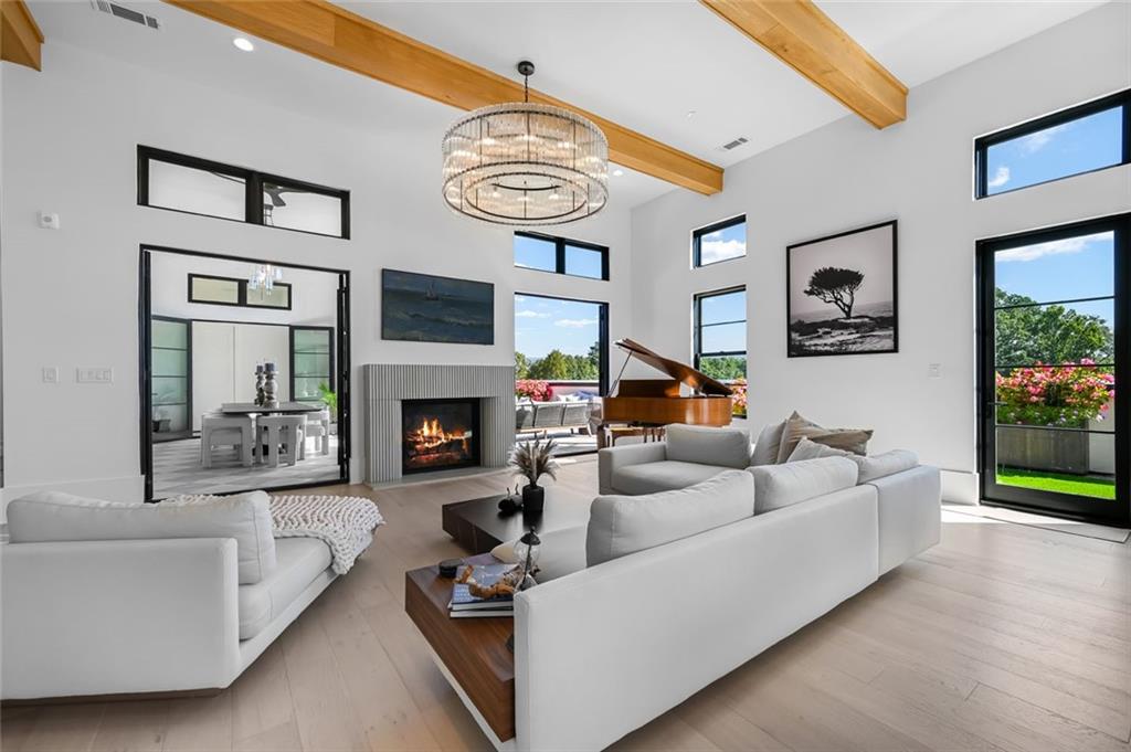 8200 Main Street, Unit 1306 Woodstock, GA 30188 - Photo 39 of 43 a living room with furniture a flat screen tv and a fireplace