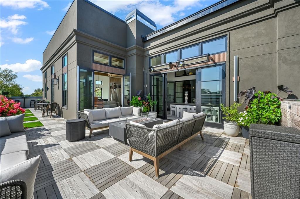 8200 Main Street, Unit 1306 Woodstock, GA 30188 - Photo 42 of 43 a view of a patio with couches table and chairs with potted plants