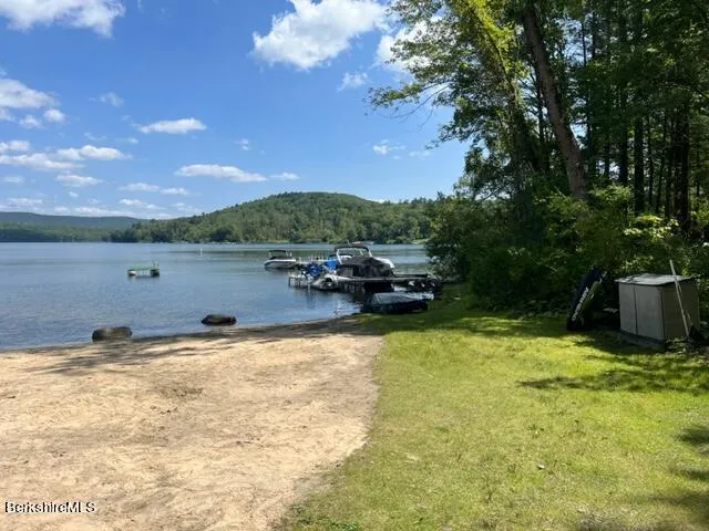 a view of a lake with houses in the back