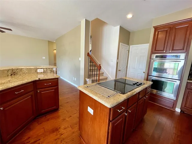 a kitchen with stainless steel appliances granite countertop a stove a sink and a refrigerator