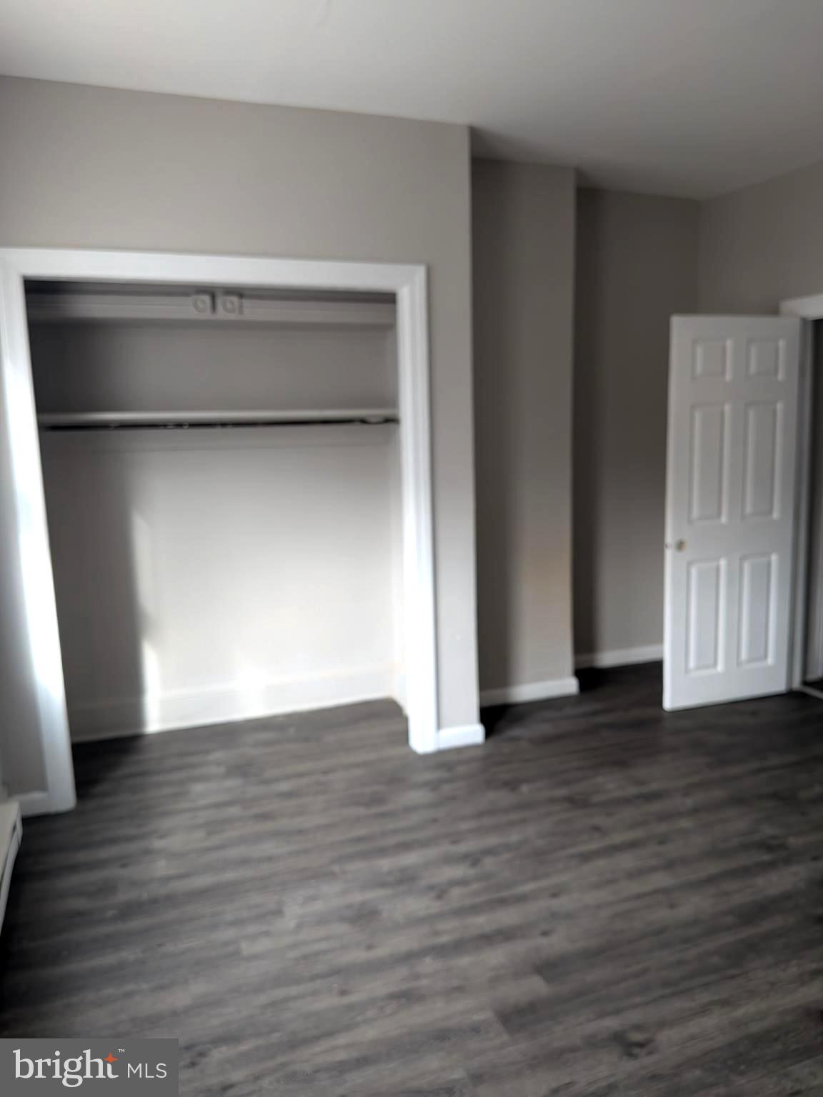 1343 West Pike Street, Unit 3 Philadelphia, PA 19140 - Photo 4 of 10 a view of an empty room with wooden floor and a window