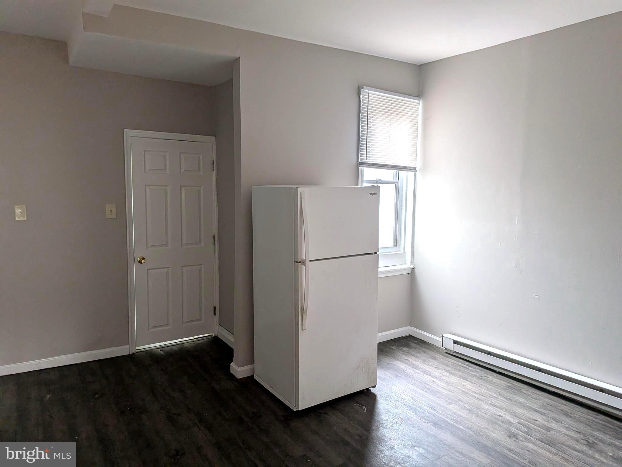 1343 West Pike Street, Unit 3 Philadelphia, PA 19140 - Photo 7 of 10 a view of a kitchen with wooden floor and window
