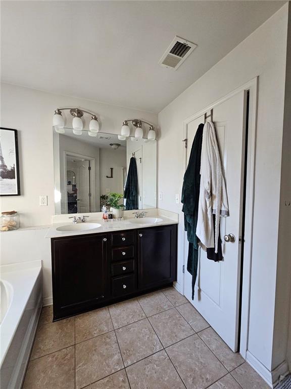 5747 Radford Loop Fairburn, GA 30213 - Photo 26 of 36 a spacious bathroom with a bathtub and a sink