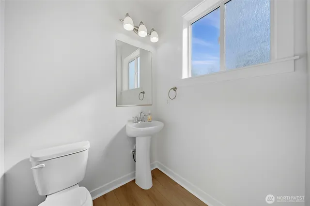 a bathroom with a sink a toilet and mirror