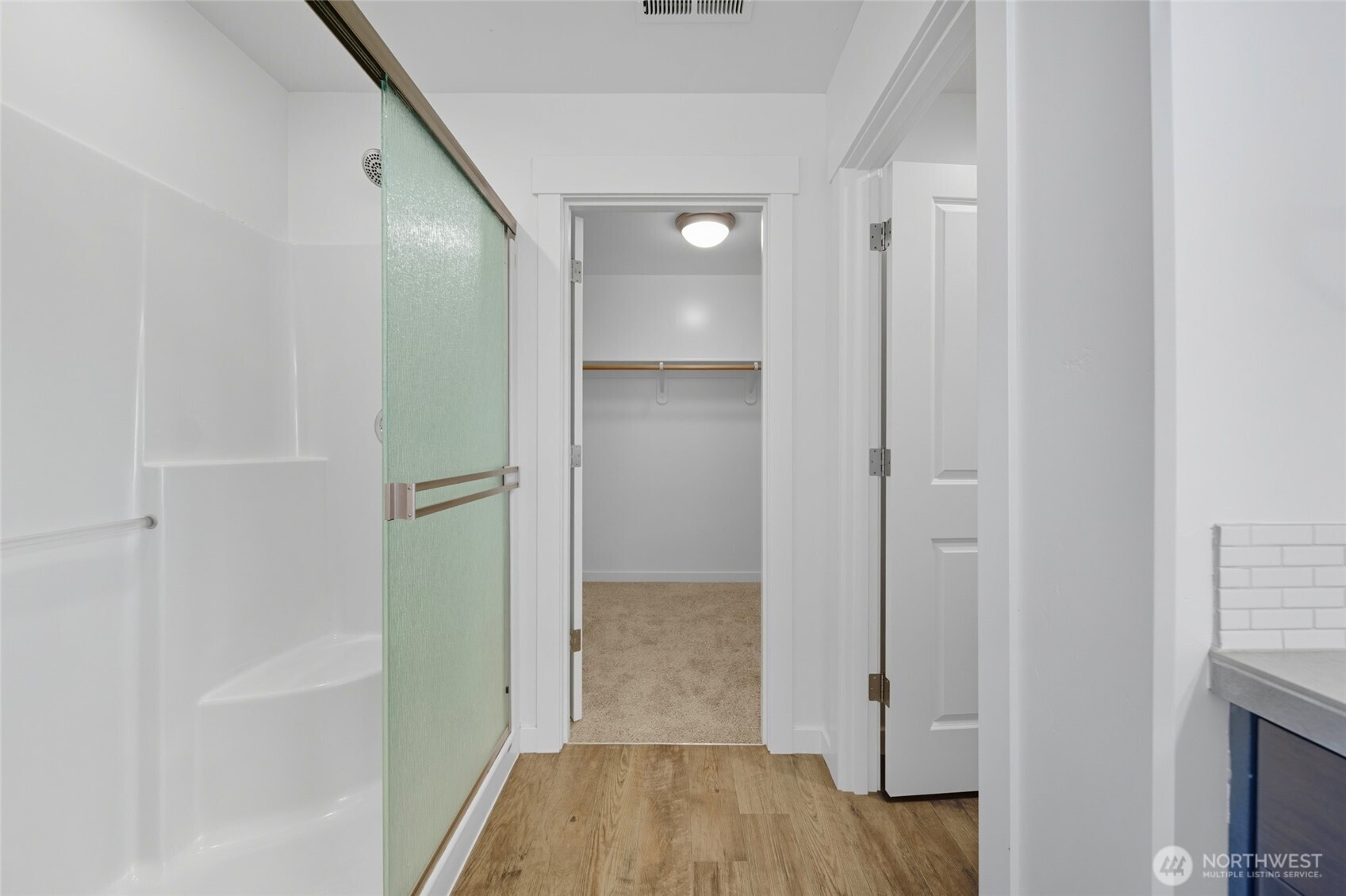 476 Reserve Way Walla Walla, WA 99362 - Photo 21 of 40 a view of a hallway with wooden floor and a bathroom