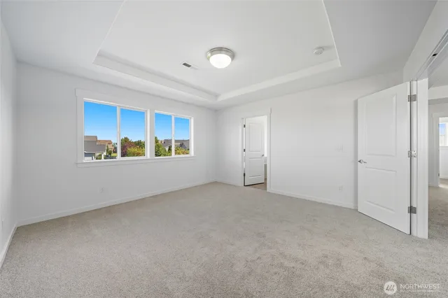 a view of an empty room with a window and workspace