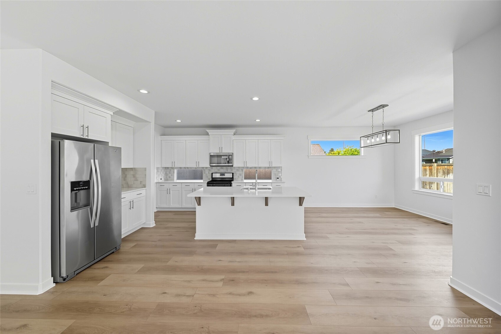 476 Reserve Way Walla Walla, WA 99362 - Photo 8 of 40 a view of kitchen with refrigerator cabinets and wooden floor