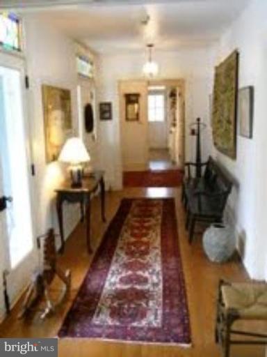 16429 Falls Road Upperco, MD 21155 - Photo 7 of 23 a view of a hallway with wooden floor and furniture