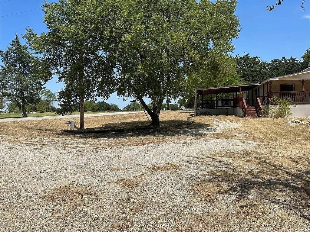 805 Lloyd's Road Little Elm, TX 75068 - Photo 15 of 19 a view of backyard with seating space and trees