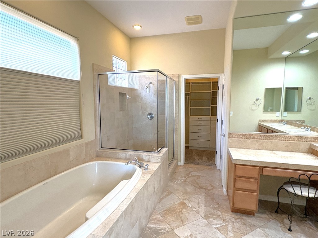 10 Caprington Road Henderson, NV 89052 - Photo 4 of 44 Luxurious bathing area features a deep soaking tub and a spacious glass-enclosed shower.