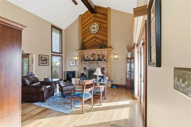 a living room with fireplace furniture and a rug