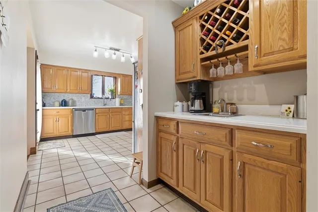 a kitchen with stainless steel appliances granite countertop a sink and cabinets