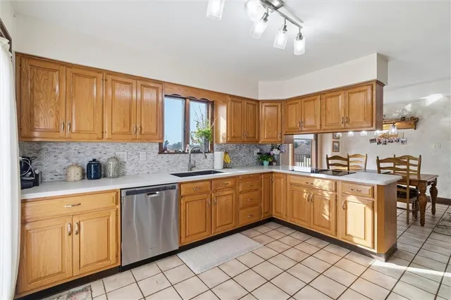 a kitchen with cabinets appliances and a window