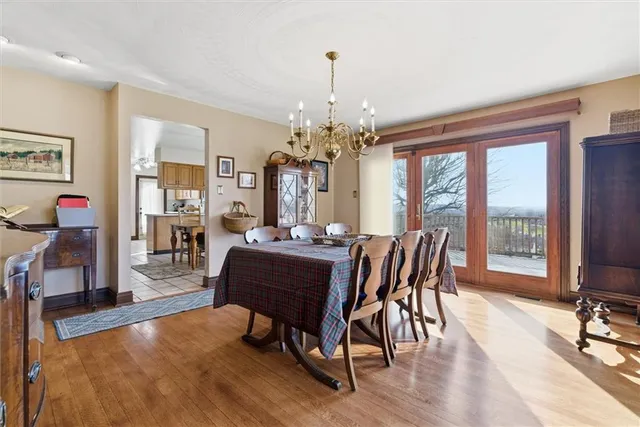 a dining room with furniture window and wooden floor