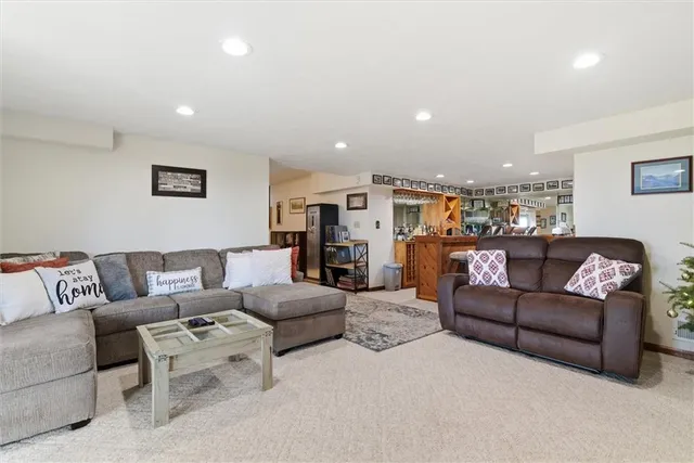 a living room with furniture a rug and a wall painting