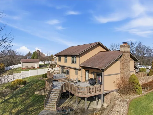 a aerial view of a house with swimming pool and sitting area
