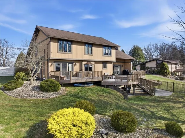 a view of a house with a big yard and potted plants