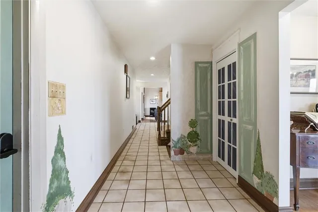 a hallway with a large mirror and shower