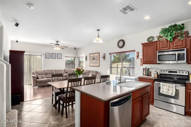 a kitchen with stainless steel appliances granite countertop a stove and a refrigerator