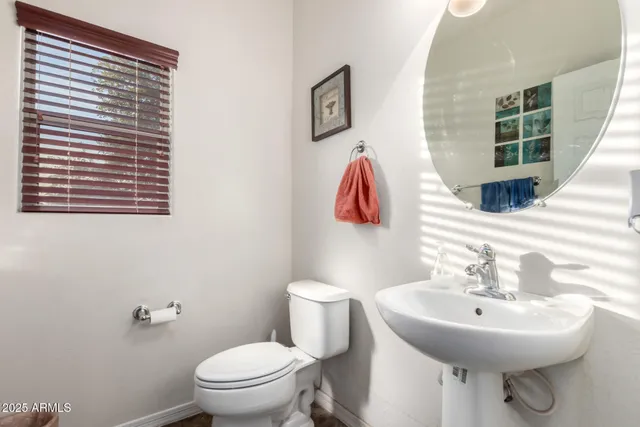 a bathroom with a sink toilet and a mirror
