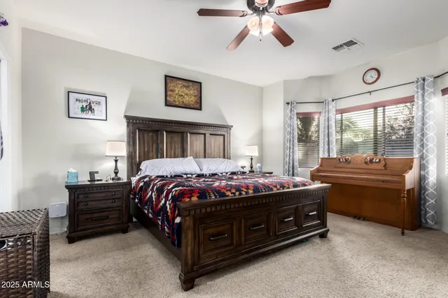 a bed sitting in a bedroom next to a window