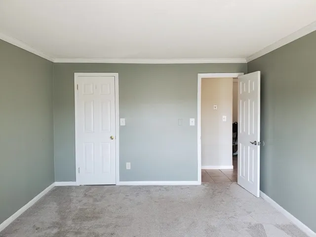 a view of an empty room and closet area
