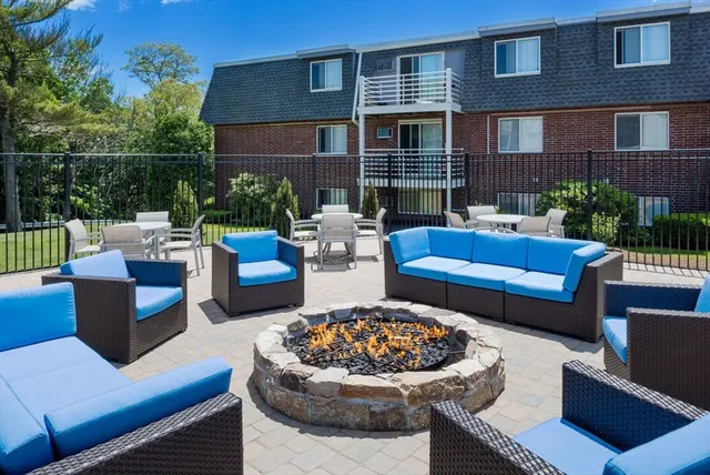 a view of a patio with couches table and chairs and potted plants