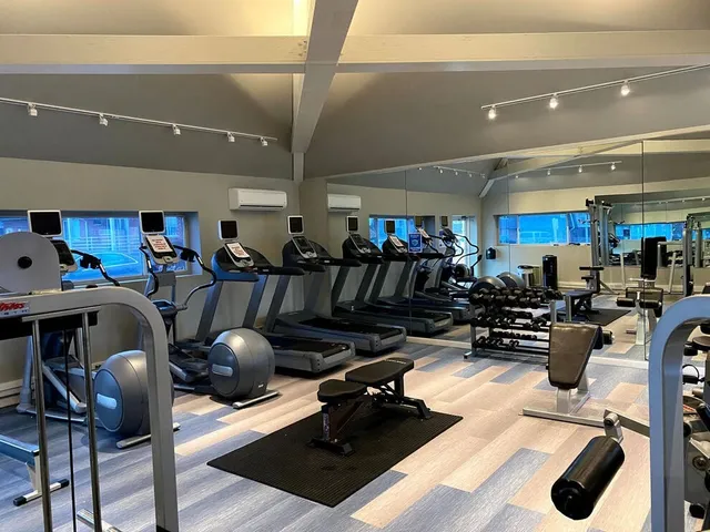 a room with lots of chairs and mirrors