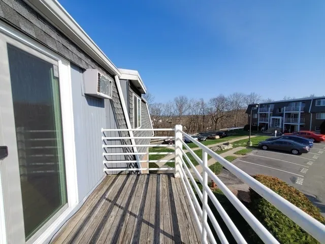 a view of a balcony with two chairs and a wooden floor