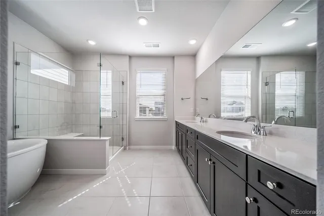 a large bathroom with a large tub shower and sink