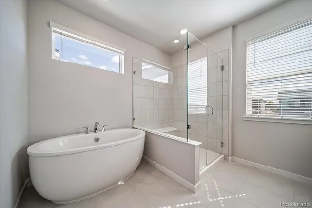 a spacious bathroom with a bathtub and shower