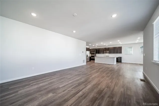 a view of kitchen with a sink and wooden floor
