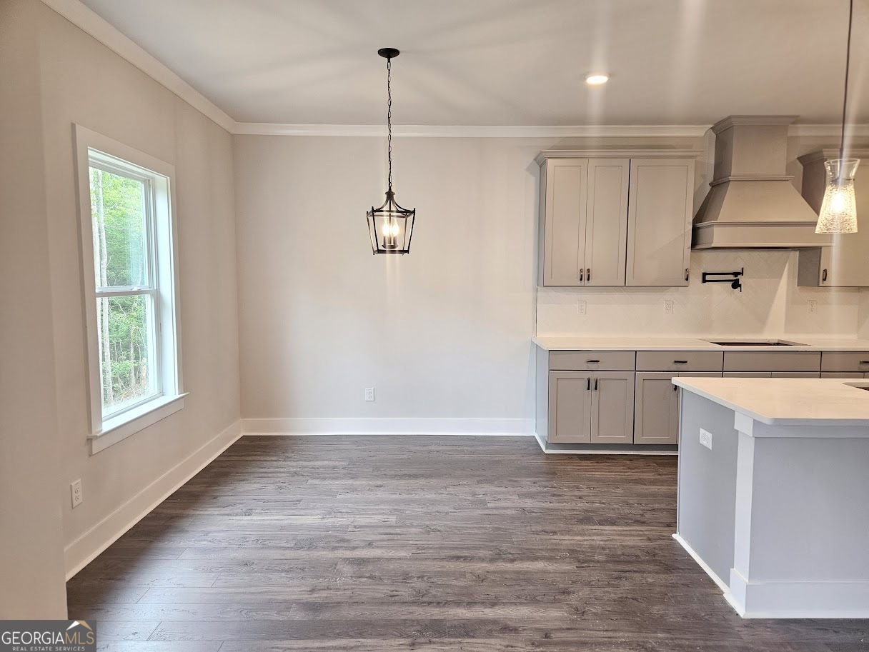 149 Silvercrest Drive, Unit 58 Acworth, GA 30101 - Photo 12 of 49 a kitchen with kitchen island a stove a sink and wooden floor