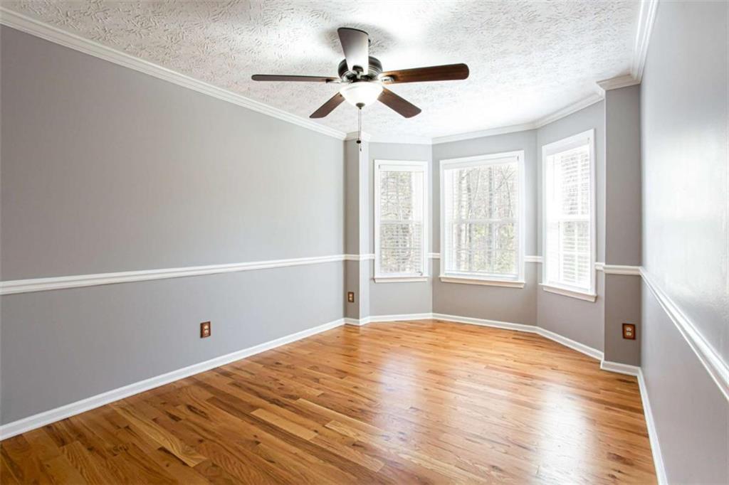 3721 Bogan Mill Road Northeast Buford, GA 30519 - Photo 19 of 58 a view of empty room with wooden floor and fan