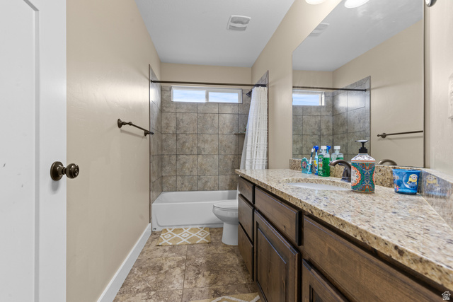 4557 North Ranch Road East Tooele, UT 84074 - Photo 18 of 43 Bathroom featuring a sink with a granite-style countertop, a built-in tub with tile surround, and a rectangular window
