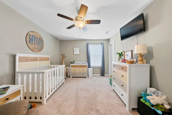 a bedroom with furniture and a flat screen tv