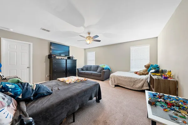 a bedroom with two beds and a dresser