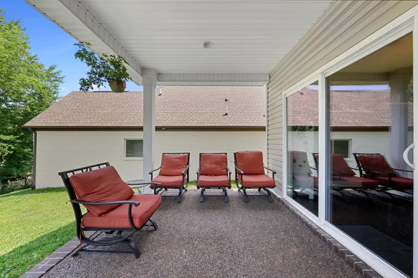 a backyard of a house with outdoor seating