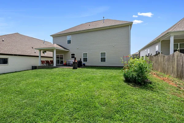 a front view of house with yard and green space