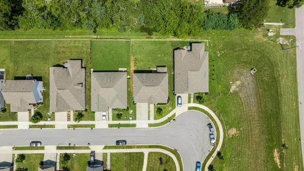 an aerial view of residential house with outdoor space and swimming pool