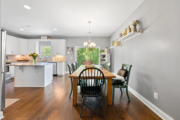 a view of a dining room with furniture window and wooden floor