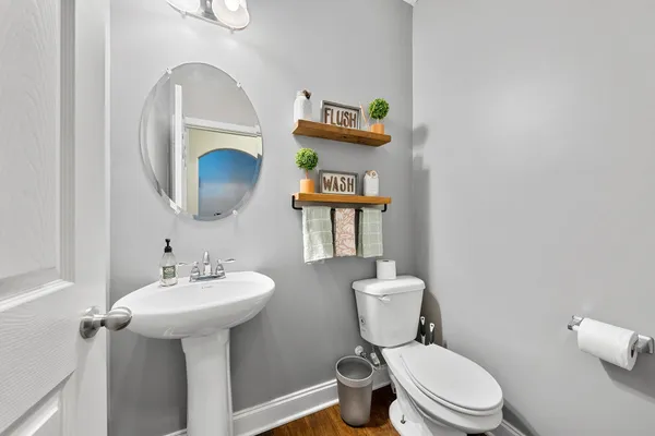 a bathroom with a toilet sink and mirror
