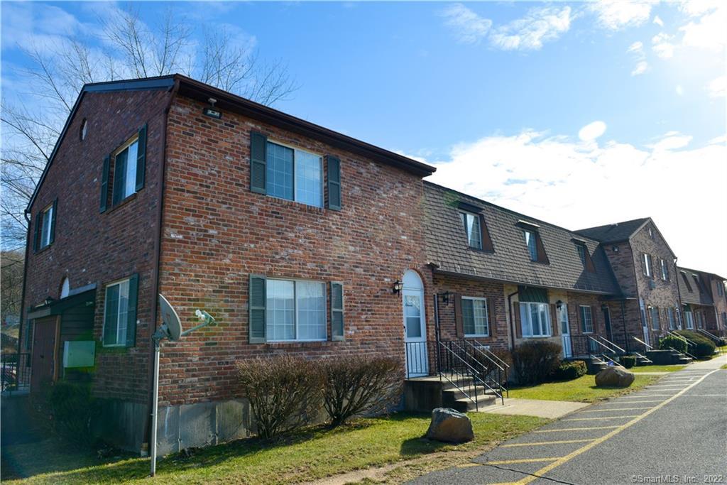 24 Sharon Road, Unit 11 Waterbury, CT 06705 - Photo 1 of 1 a front view of a house with garden