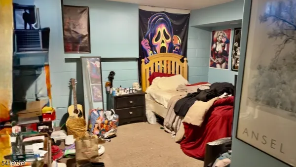 a bedroom with two bed and paintings on the wall in it