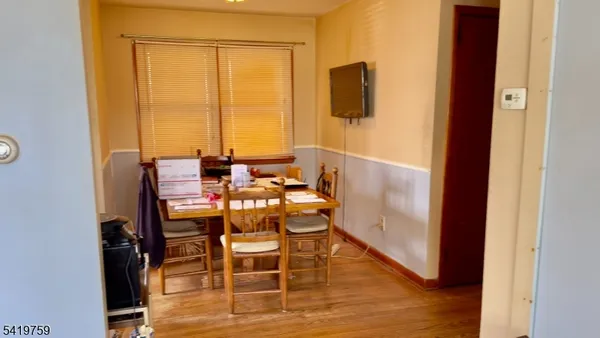 a dining room with furniture and wooden floor