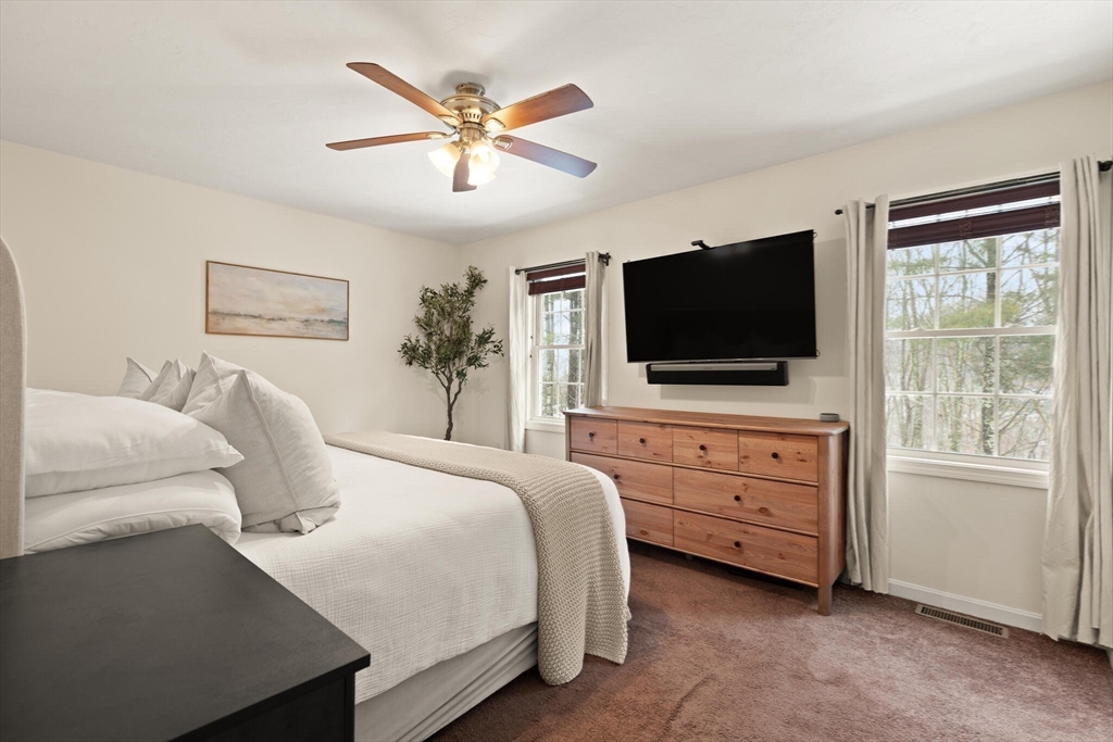 41 Boston Road, Unit 485 Billerica, MA 01862 - Photo 12 of 19 a bedroom with a bed and a flat screen tv