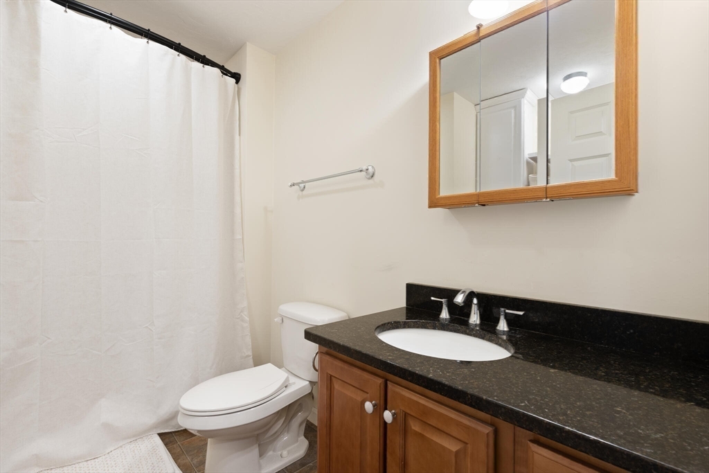 41 Boston Road, Unit 485 Billerica, MA 01862 - Photo 14 of 19 a bathroom with a granite countertop sink and a toilet
